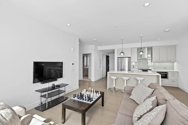 living room featuring sink and light wood-type flooring