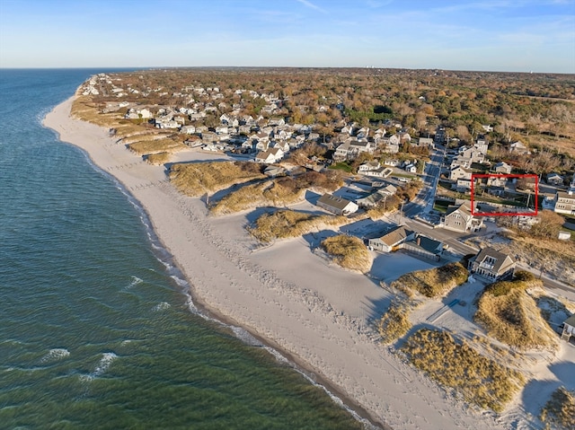 drone / aerial view featuring a beach view and a water view