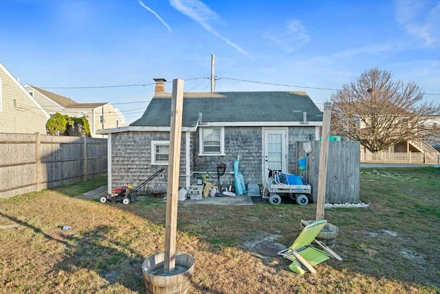 back of property with a patio area and a yard