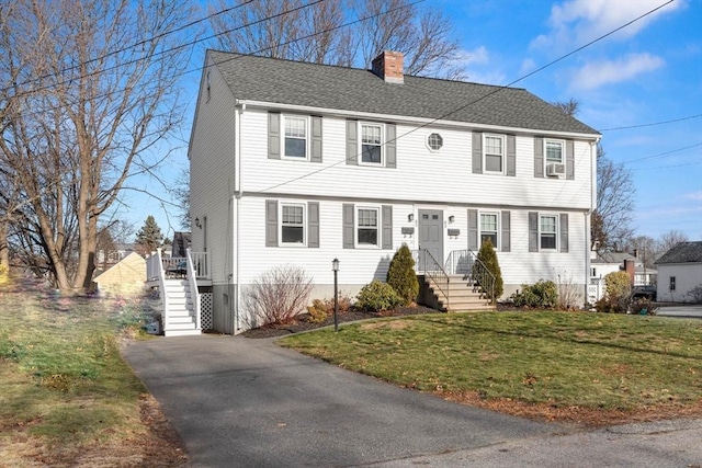 colonial-style house with a front lawn