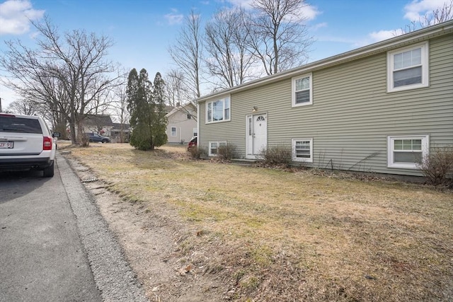 view of home's exterior with a yard