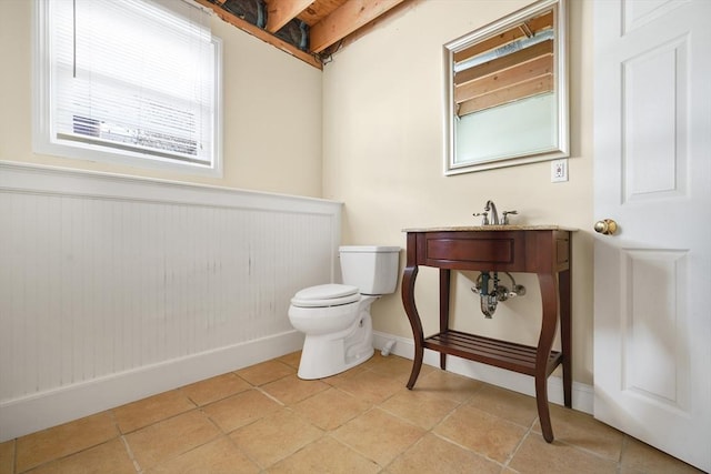 bathroom featuring baseboards, toilet, and tile patterned floors