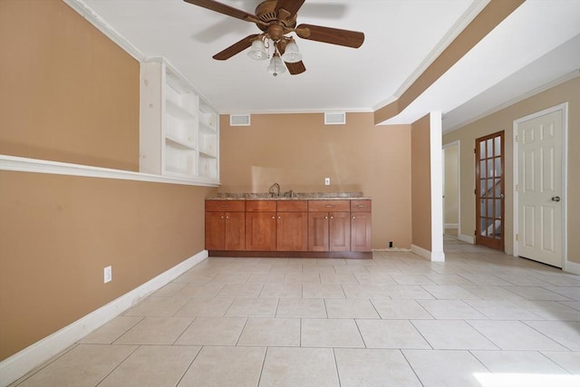 unfurnished room with visible vents, crown molding, and baseboards