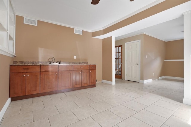 interior space with ornamental molding, visible vents, and a ceiling fan