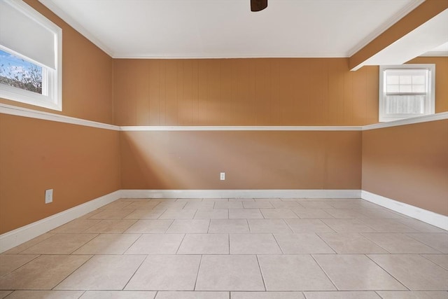 spare room featuring light tile patterned floors and baseboards