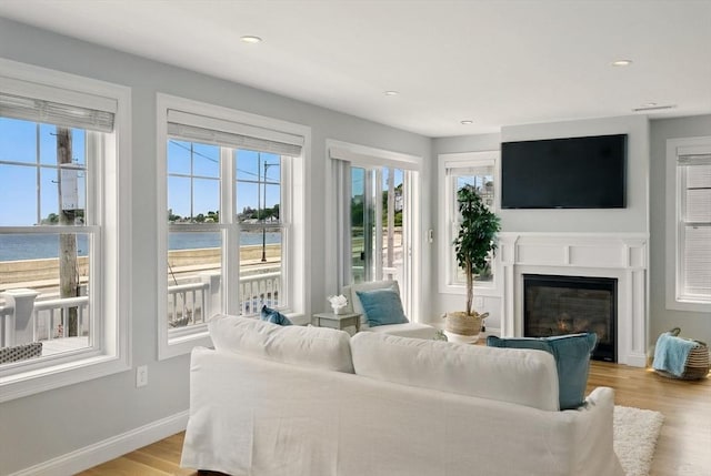 1089 Winthrop Ave Unit A, Revere, MA 02151 - living area with a water view, a glass covered fireplace, light wood finished floors, baseboards, and recessed lighting