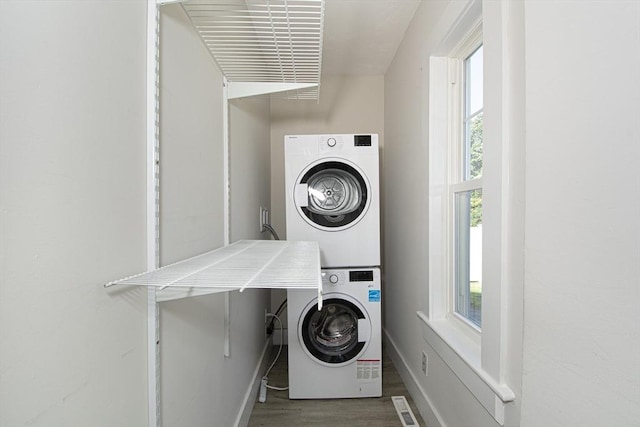 29 Maple St Unit 2, Uxbridge, MA 01569 - washroom with stacked washer / dryer and wood finished floors