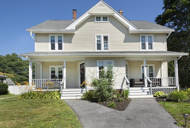 29 Maple St Unit 2, Uxbridge, MA 01569 - view of front of house with covered porch, a chimney, a front yard, and a shingled roof