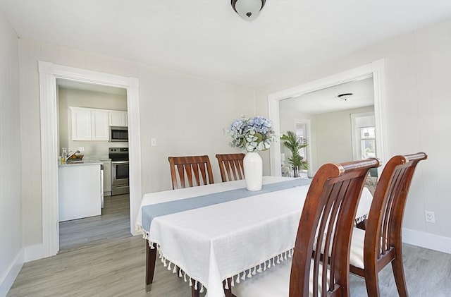 29 Maple St Unit 2, Uxbridge, MA 01569 - dining room with light wood-style floors and baseboards
