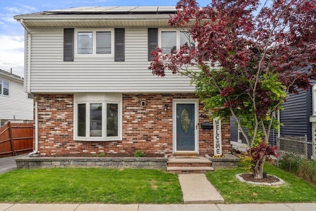 40 Fowler Ave, Revere, MA 02151 - view of front of home with solar panels and brick siding
