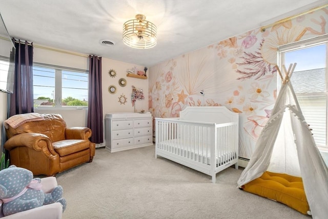40 Fowler Ave, Revere, MA 02151 - bedroom with wallpapered walls, light carpet, and a crib