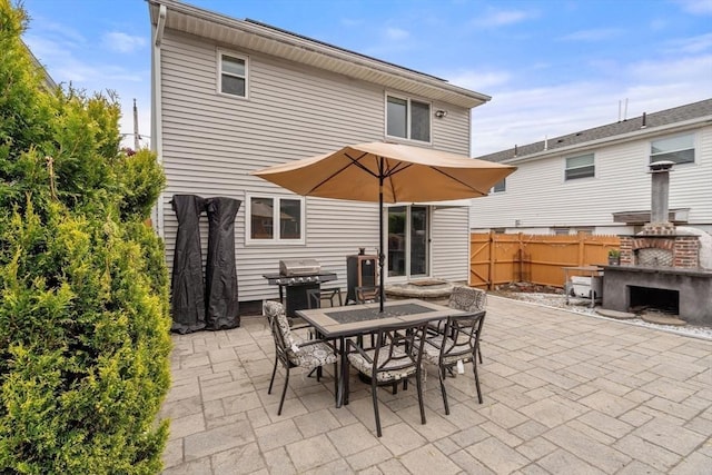 40 Fowler Ave, Revere, MA 02151 - back of property with outdoor dining space, a patio area, and a fireplace
