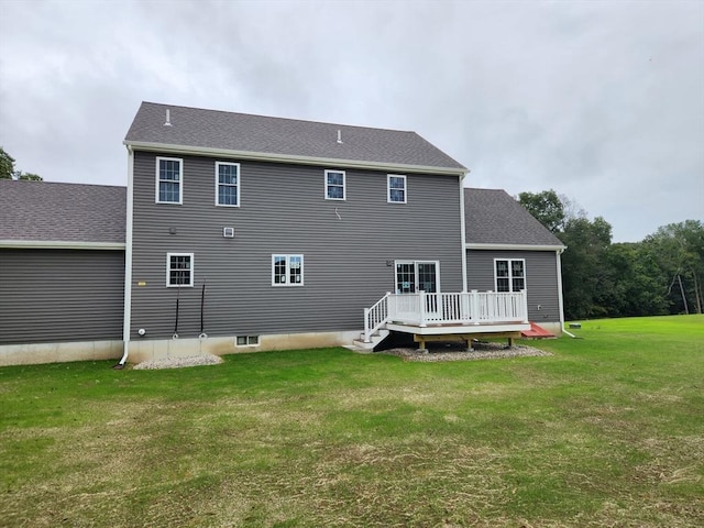 back of house featuring a deck and a yard