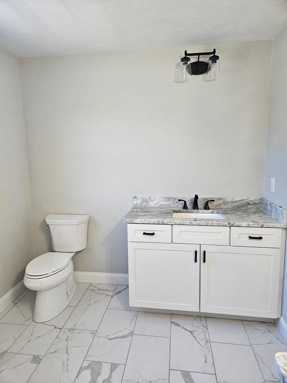 bathroom featuring toilet and vanity