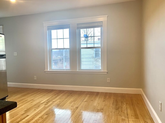 interior space featuring light wood-type flooring and baseboards