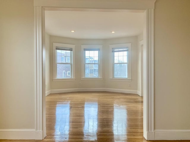 empty room with recessed lighting, baseboards, and light wood-style floors