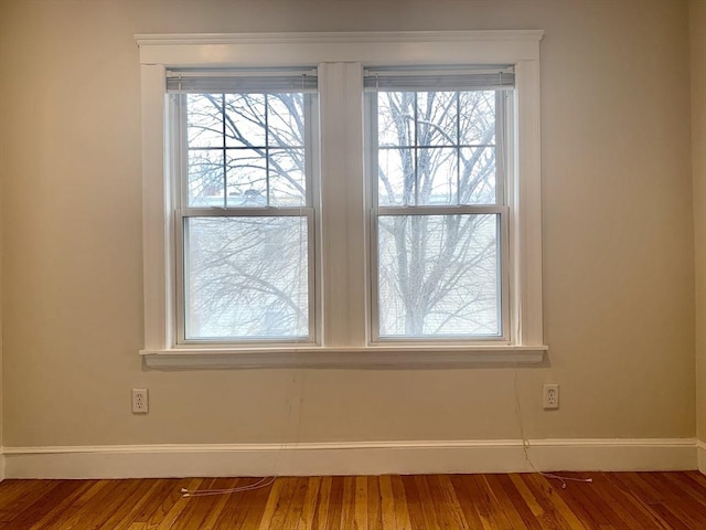 room details featuring baseboards and wood finished floors