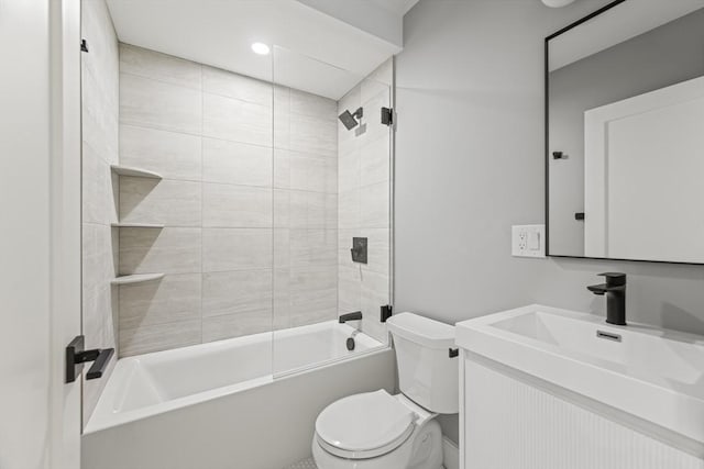 full bathroom with toilet, vanity, and tiled shower / bath