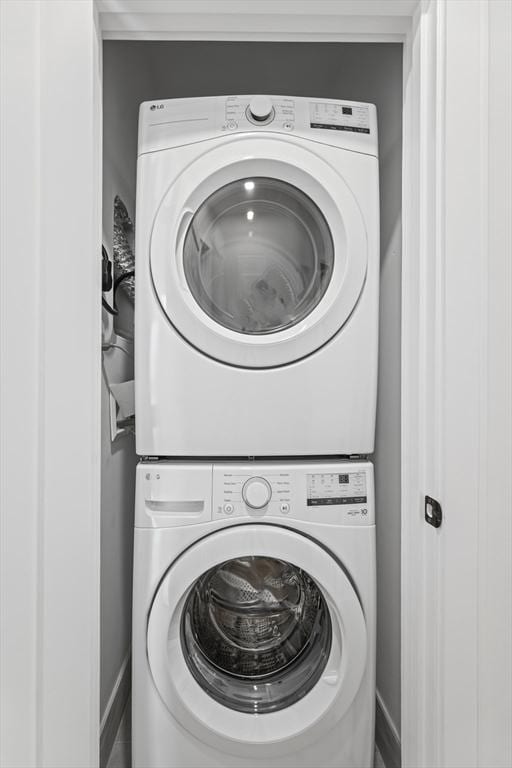 laundry room with stacked washer and clothes dryer