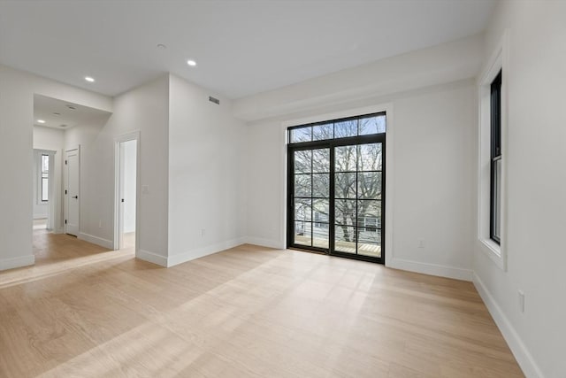 unfurnished room with light hardwood / wood-style flooring