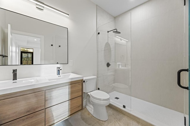 bathroom featuring vanity, walk in shower, and toilet