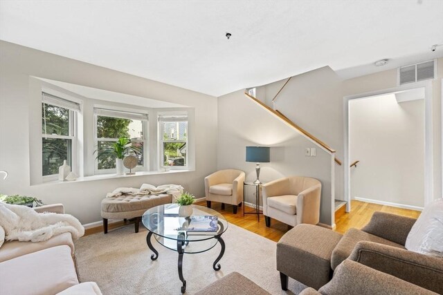289 Market St Unit B, Boston, MA 02135 - living area featuring light wood-type flooring, baseboards, and stairway