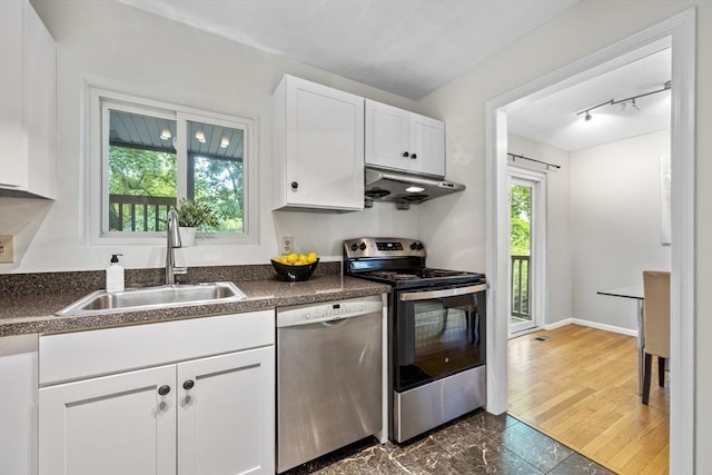 289 Market St Unit B, Boston, MA 02135 - kitchen featuring appliances with stainless steel finishes, a sink, under cabinet range hood, and dark countertops