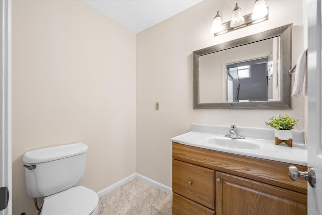 289 Market St Unit B, Boston, MA 02135 - half bathroom with baseboards, toilet, vanity, and marble look tile flooring