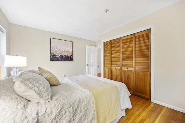 289 Market St Unit B, Boston, MA 02135 - bedroom featuring a closet, light wood-type flooring, and baseboards
