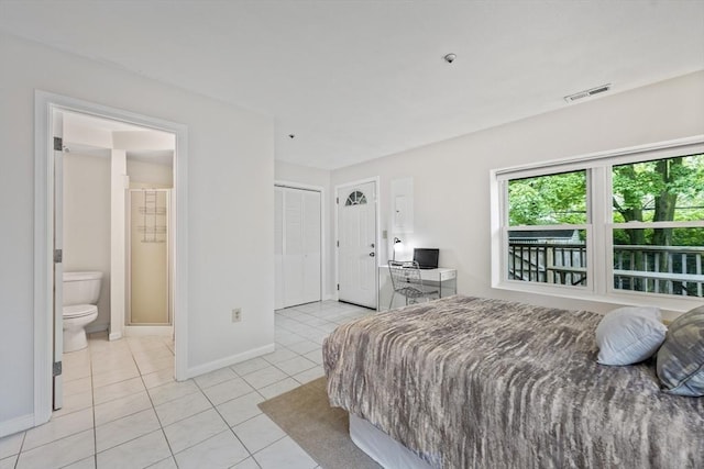 289 Market St Unit B, Boston, MA 02135 - bedroom with light tile patterned floors, baseboards, connected bathroom, a desk, and a closet