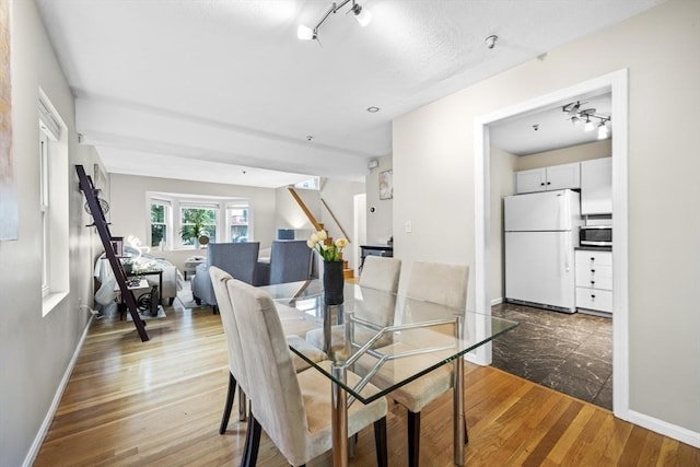 289 Market St Unit B, Boston, MA 02135 - dining room with track lighting, wood finished floors, stairs, and baseboards