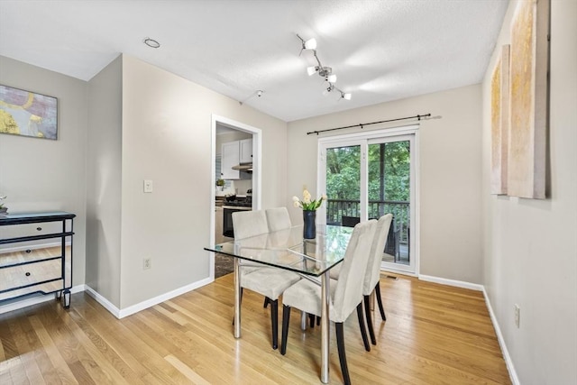 289 Market St Unit B, Boston, MA 02135 - dining area with light wood finished floors, baseboards, track lighting, and a textured ceiling
