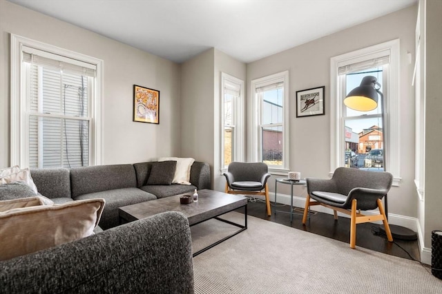 living area featuring plenty of natural light, wood finished floors, and baseboards