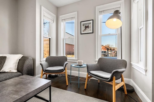 sitting room featuring dark wood-type flooring and baseboards