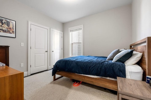 carpeted bedroom featuring baseboards