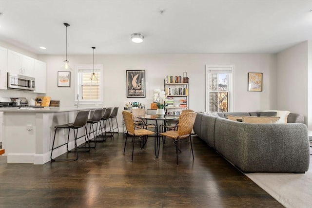 dining space featuring dark wood-style floors, plenty of natural light, and recessed lighting