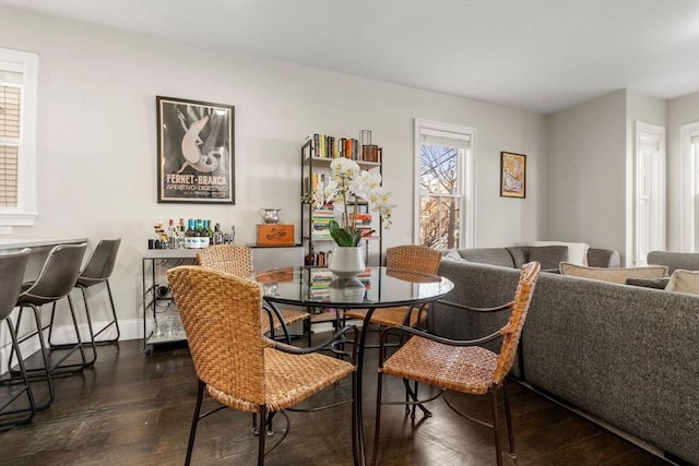 dining room with dark wood-style floors and baseboards