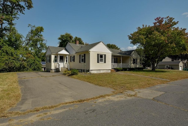 view of front of home with a porch and a front yard