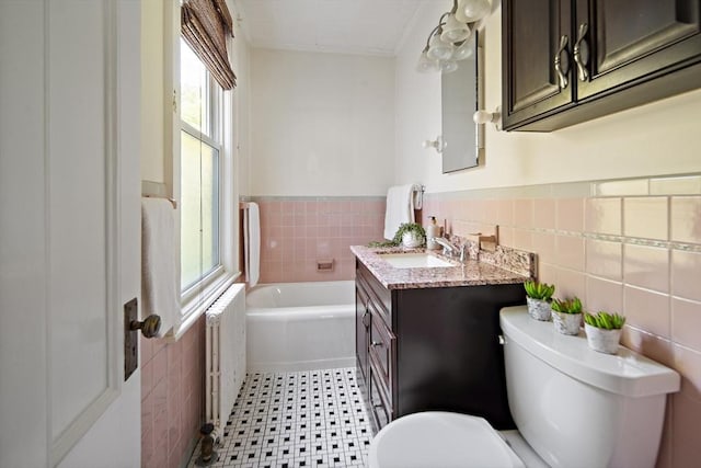 38 Spring St, Somerville, MA 02143 - bathroom with tile walls, radiator, a bath, wainscoting, and vanity