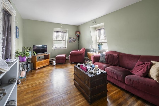 38 Spring St, Somerville, MA 02143 - living room with healthy amount of natural light, wood finished floors, baseboard heating, and a baseboard radiator