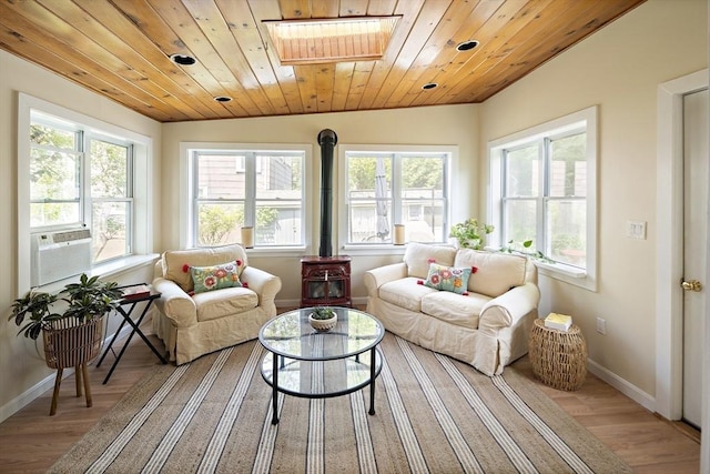 38 Spring St, Somerville, MA 02143 - sunroom / solarium featuring a skylight, a wood stove, and cooling unit