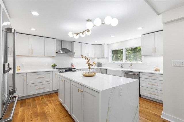 14 Corcoran Rd, Burlington, MA 01803 - kitchen featuring wall chimney exhaust hood, appliances with stainless steel finishes, backsplash, light wood-style floors, and recessed lighting