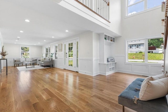 14 Corcoran Rd, Burlington, MA 01803 - living room featuring light wood finished floors, recessed lighting, a decorative wall, and a wainscoted wall