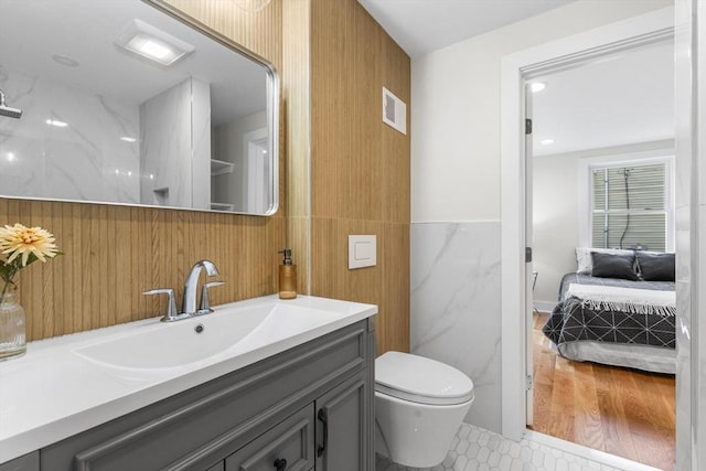14 Corcoran Rd, Burlington, MA 01803 - ensuite bathroom featuring tile walls, vanity, and tile patterned floors