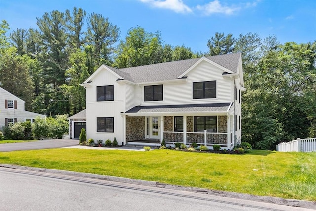 14 Corcoran Rd, Burlington, MA 01803 - view of front facade with a porch, stone siding, asphalt driveway, a garage, and view of scattered trees