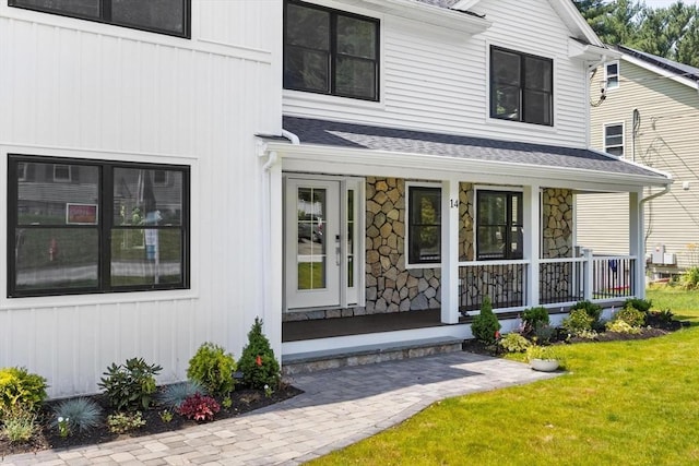 14 Corcoran Rd, Burlington, MA 01803 - doorway to property with covered porch, roof with shingles, and a yard