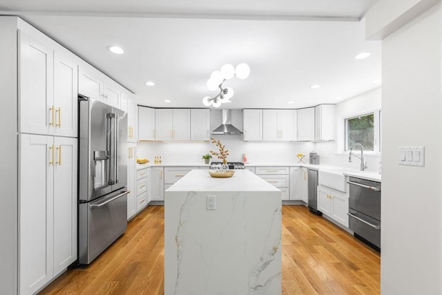 14 Corcoran Rd, Burlington, MA 01803 - kitchen with stainless steel appliances, wall chimney exhaust hood, a center island, backsplash, and light stone countertops