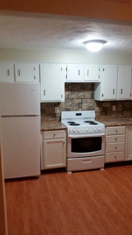 kitchen with white cabinetry, light hardwood / wood-style flooring, and white appliances