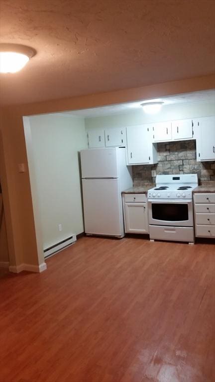 kitchen featuring white appliances, a baseboard heating unit, white cabinets, tasteful backsplash, and light hardwood / wood-style floors