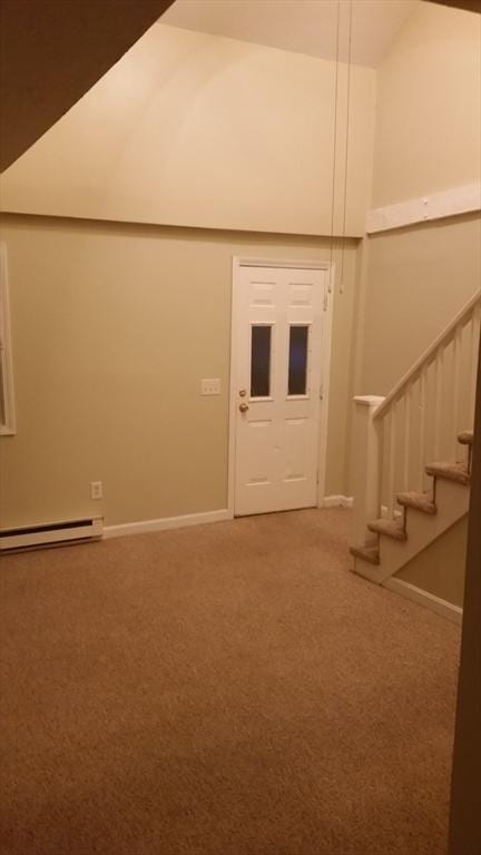 interior space featuring carpet flooring and a baseboard heating unit